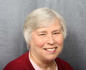 A happy patient shows off her beautiful smile after being restored with porcelain crowns