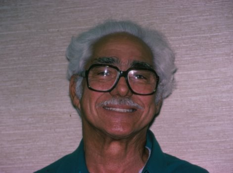 A very happy patient with his dental implants securely holding his new teeth in place