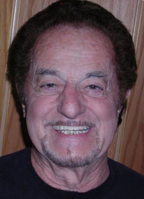 A very happy patient with his new bridge affixed to dental implants