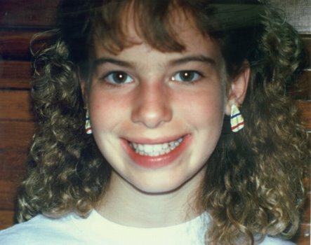 A happy patient after her overbite was corrected by a simple retainer