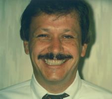 A happy patient's smile after the gap in his front teeth was restored with porcelain laminates